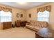 Home office featuring a sofa bed, wooden desk, and two windows at 2541 Pinewood Rd, Gastonia, NC 28054