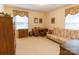 Home office with a sofa bed, wooden desk, and two windows at 2541 Pinewood Rd, Gastonia, NC 28054