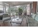 Relaxing screened porch with tiled floor and metal furniture at 2541 Pinewood Rd, Gastonia, NC 28054