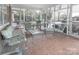 Enclosed porch with tiled floor and comfy seating at 2541 Pinewood Rd, Gastonia, NC 28054