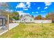 Charming single-story home showcasing a spacious, grassy backyard with a concrete patio and white picket fence at 27 Dove Sw Ave, Concord, NC 28025