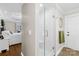 Modern bathroom features a glass-enclosed shower and neutral tones, complemented by access to the main bedroom at 27 Dove Sw Ave, Concord, NC 28025