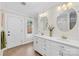 Bright bathroom features dual sinks, white cabinetry, and plenty of natural light from the window at 27 Dove Sw Ave, Concord, NC 28025