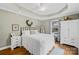 Cozy bedroom features soft green walls, a tray ceiling, and a large window for natural light at 27 Dove Sw Ave, Concord, NC 28025