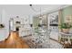 Inviting breakfast area features a round glass table, white chairs, and abundant natural light from large windows at 27 Dove Sw Ave, Concord, NC 28025