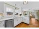 Stylish kitchen features white countertops and cabinetry, stainless steel appliances, and backyard view windows at 27 Dove Sw Ave, Concord, NC 28025