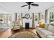 Cozy living room featuring a fireplace, hardwood floors, ample seating, and plenty of natural light at 27 Dove Sw Ave, Concord, NC 28025