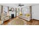 Bright living room with fireplace, hardwood floors, and comfortable seating near sunny windows at 27 Dove Sw Ave, Concord, NC 28025