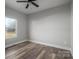 This bedroom features wood-look floors, a ceiling fan, and a bright window at 2832 12Th Sw Ave, Hickory, NC 28602