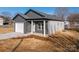 Charming gray single Gathering home featuring a one car garage, concrete driveway and covered porch at 2832 12Th Sw Ave, Hickory, NC 28602