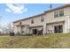 Back of home features an outdoor patio area, grassy yard, and well-maintained siding at 3028 Summerfield Ridge Ln, Matthews, NC 28105