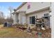 Backyard features two wooden chairs, a fence and storage shelf, and a well-manicured lawn at 3028 Summerfield Ridge Ln, Matthews, NC 28105