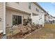 Backyard patio features two wooden chairs, a fence and storage shelf, and sliding glass doors at 3028 Summerfield Ridge Ln, Matthews, NC 28105