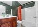 Bathroom featuring wood cabinets, a large mirror, a vanity sink, and tiled floors at 3028 Summerfield Ridge Ln, Matthews, NC 28105