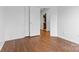 Bedroom with wood-look floors, double door closet and ensuite bathroom access at 3028 Summerfield Ridge Ln, Matthews, NC 28105