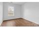 Bright bedroom with wood-look floors, and a large window providing great natural light at 3028 Summerfield Ridge Ln, Matthews, NC 28105