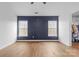 Clean bedroom featuring wood-look floors, modern ceiling fan, and a sunny window at 3028 Summerfield Ridge Ln, Matthews, NC 28105