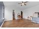 Bedroom with wood floors, ceiling fan, and attached ensuite bathroom and walk-in closet at 3028 Summerfield Ridge Ln, Matthews, NC 28105