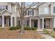 Charming townhome with brick accents, a cozy porch, and a mature tree at 3028 Summerfield Ridge Ln, Matthews, NC 28105