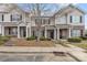 Charming townhomes with brick accents, cozy porches, and mature trees at 3028 Summerfield Ridge Ln, Matthews, NC 28105