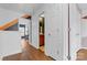 Hallway features hardwood floors, white trim, and views to the study and bathroom at 3028 Summerfield Ridge Ln, Matthews, NC 28105