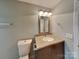 Cozy bathroom with a vanity with a tile countertop and a large mirror at 3029 Winding Trl, Matthews, NC 28105