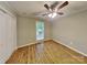 Cozy bedroom with hardwood floors, ceiling fan, and ample closet space at 3029 Winding Trl, Matthews, NC 28105