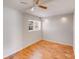 Bright bedroom with hardwood floors, a ceiling fan, and ample natural light from the window at 3029 Winding Trl, Matthews, NC 28105