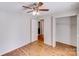 A bedroom featuring wood flooring and a ceiling fan plus a closet and doorway to another room at 3029 Winding Trl, Matthews, NC 28105