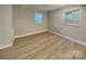 This spacious bedroom features new flooring and ample natural light at 3029 Winding Trl, Matthews, NC 28105