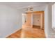 View of a bedroom with wood flooring, closet and a glimpse of a staircase at 3029 Winding Trl, Matthews, NC 28105