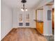 Bright dining area with double doors leading to the deck, hardwood floors, and a breakfast bar at 3029 Winding Trl, Matthews, NC 28105