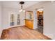 Dining area featuring hardwood floors, elegant lighting, and access to outdoor deck at 3029 Winding Trl, Matthews, NC 28105