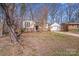 Traditional home with brick details, an attached garage, and surrounded by mature trees creating privacy at 3029 Winding Trl, Matthews, NC 28105