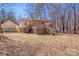 Exterior shot of the home's backyard with a deck, stairs, and siding at 3029 Winding Trl, Matthews, NC 28105