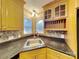 Well-lit kitchen featuring wood cabinets, granite countertops, and a stainless steel sink at 3029 Winding Trl, Matthews, NC 28105