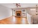 Inviting living room featuring a brick fireplace, hardwood floors, and sunlit windows at 3029 Winding Trl, Matthews, NC 28105