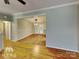 Open living area with hardwood floors and access to dining room at 3029 Winding Trl, Matthews, NC 28105