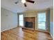 Bright living room features hardwood floors, fireplace, and large windows for ample natural light at 3029 Winding Trl, Matthews, NC 28105