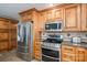 Modern kitchen featuring stainless steel appliances and wood cabinets at 3044 Old Church Rd, Gastonia, NC 28052