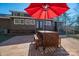 Patio area with table, chairs, and red umbrella at 3044 Old Church Rd, Gastonia, NC 28052