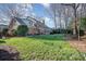 Lush backyard featuring a well-manicured lawn, patio, sunroom, and the beautiful brick architecture at 3421 Walston Ln, Charlotte, NC 28211