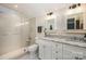 Bright bathroom featuring double sinks with granite countertops and a glass-enclosed shower at 3421 Walston Ln, Charlotte, NC 28211