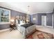 Cozy bedroom with natural light, neutral paint, carpet floors, and a chandelier at 3421 Walston Ln, Charlotte, NC 28211