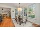 Bright breakfast nook with large windows overlooking the backyard and a rustic wooden table at 3421 Walston Ln, Charlotte, NC 28211