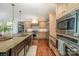 Gourmet kitchen featuring stainless steel appliances, a center island, and hardwood floors at 3421 Walston Ln, Charlotte, NC 28211