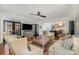 Spacious living room with hardwood floors, a ceiling fan, and an open floor plan leading to the kitchen at 3421 Walston Ln, Charlotte, NC 28211