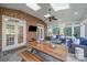 Spacious sunroom boasts a brick accent wall, dining table, and ample seating for entertaining guests at 3421 Walston Ln, Charlotte, NC 28211