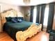 Main bedroom with large ornate bed and teal bedding at 35 Marsh Ave, Wadesboro, NC 28170