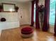 Living room with hardwood floors, fireplace, and red accents at 35 Marsh Ave, Wadesboro, NC 28170